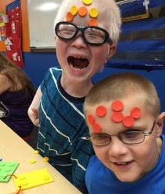 Braille dots on BELL students' faces